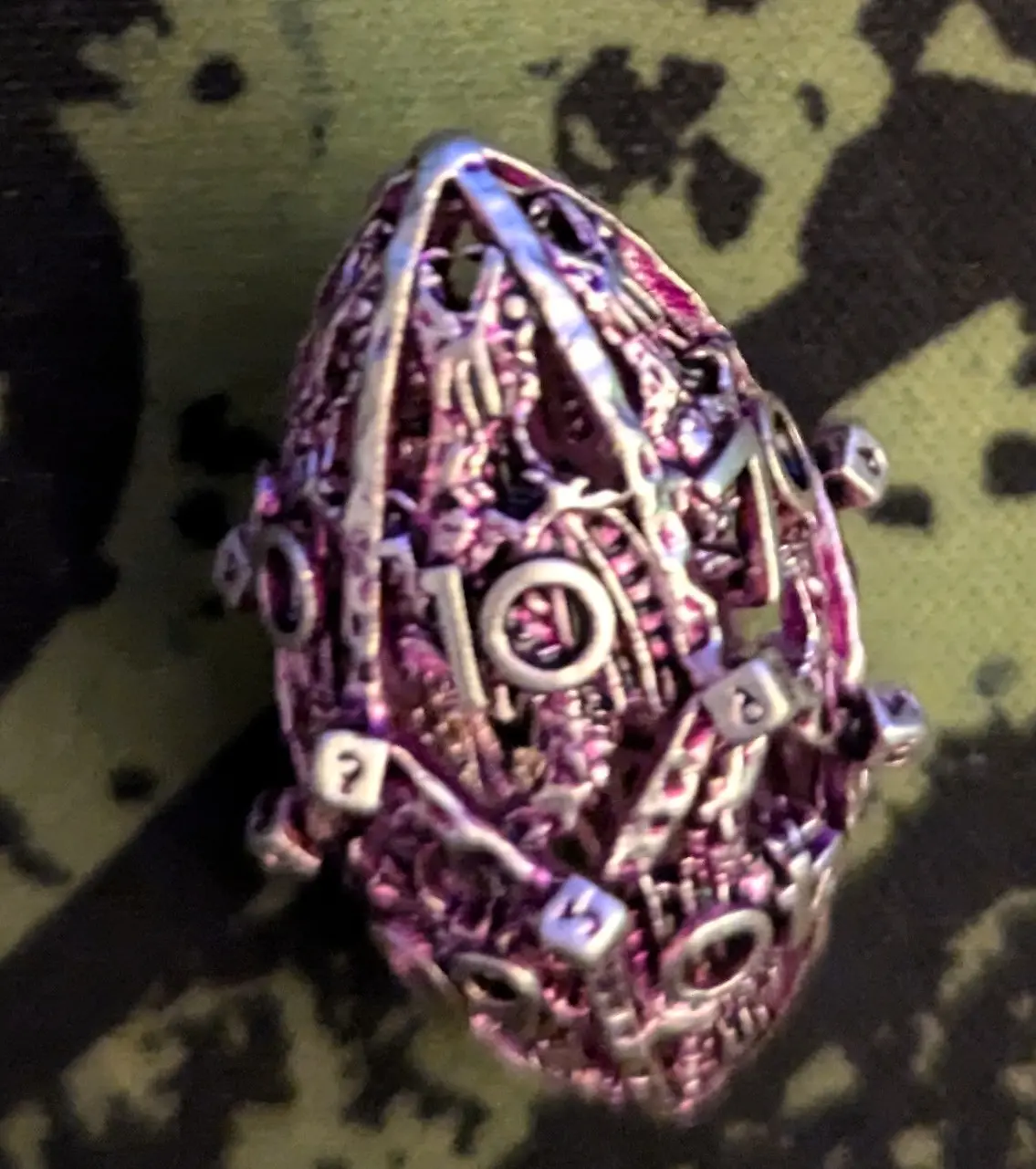 Image of an egg-formed d20 dice showing the number 10.